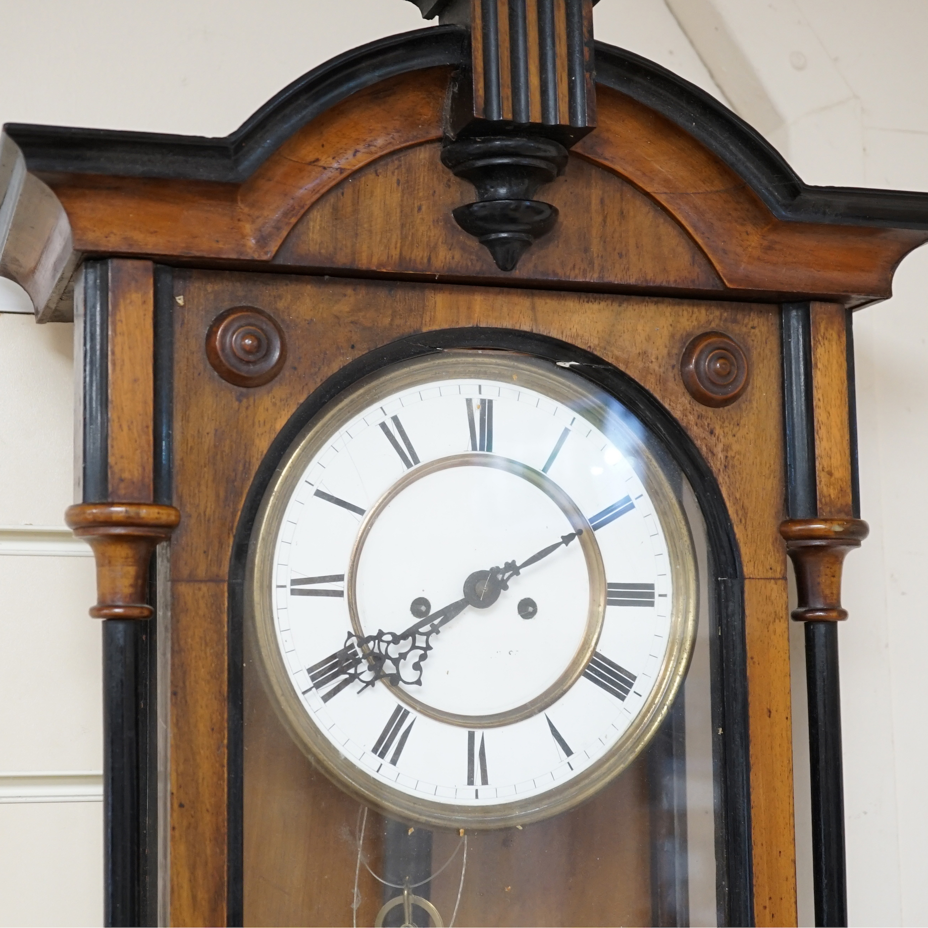 A 19th century Viennese regulator with key and weights, striking on a coiled gong, 107cm high